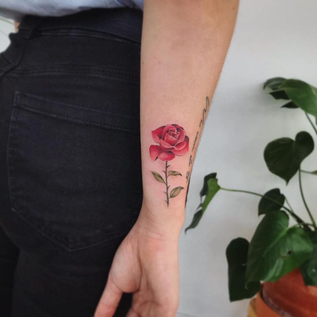 red rose tattoo on woman's wrist