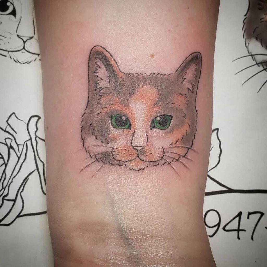 cat tattoo on wrist