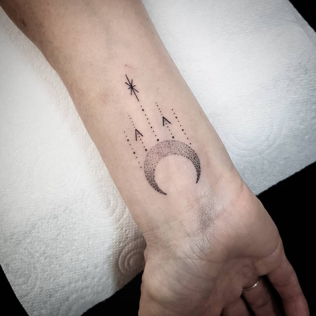 small moon tattoo on wrist