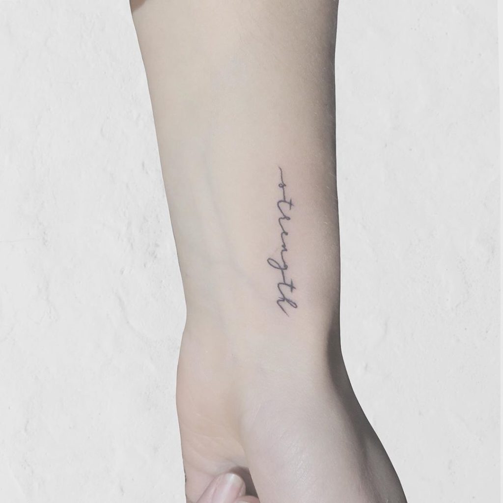 Strenght written on wrist tattoo