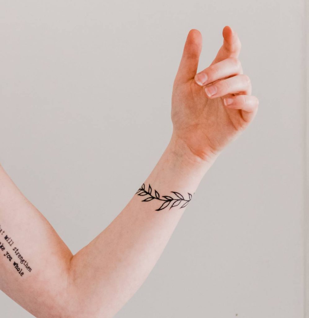 a woman's arm with a wrist tattoo