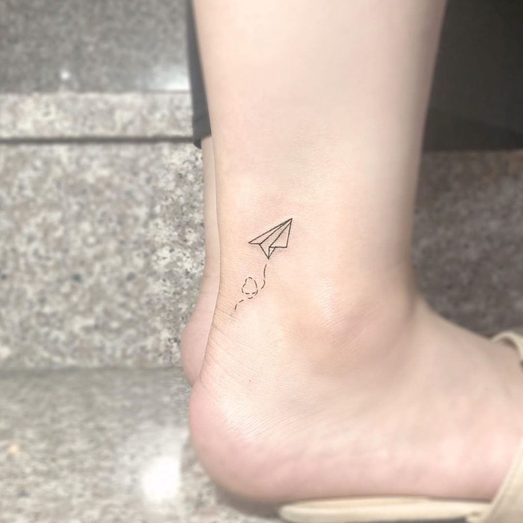 Airplane Minimalist tattoo on Ankle - Fine Line style by tattoo_zitae
