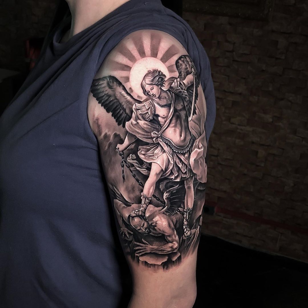 Black and grey St Michael Archangel tattoo on the upper