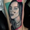 Billie Eilish portrait tattoo on Thigh (side) - Realism style by Mihail Kogut