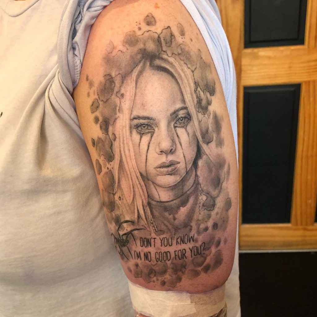 Billie Eilish portrait tattoo on Arm (upper) - Black and Grey style by Holly Robertson