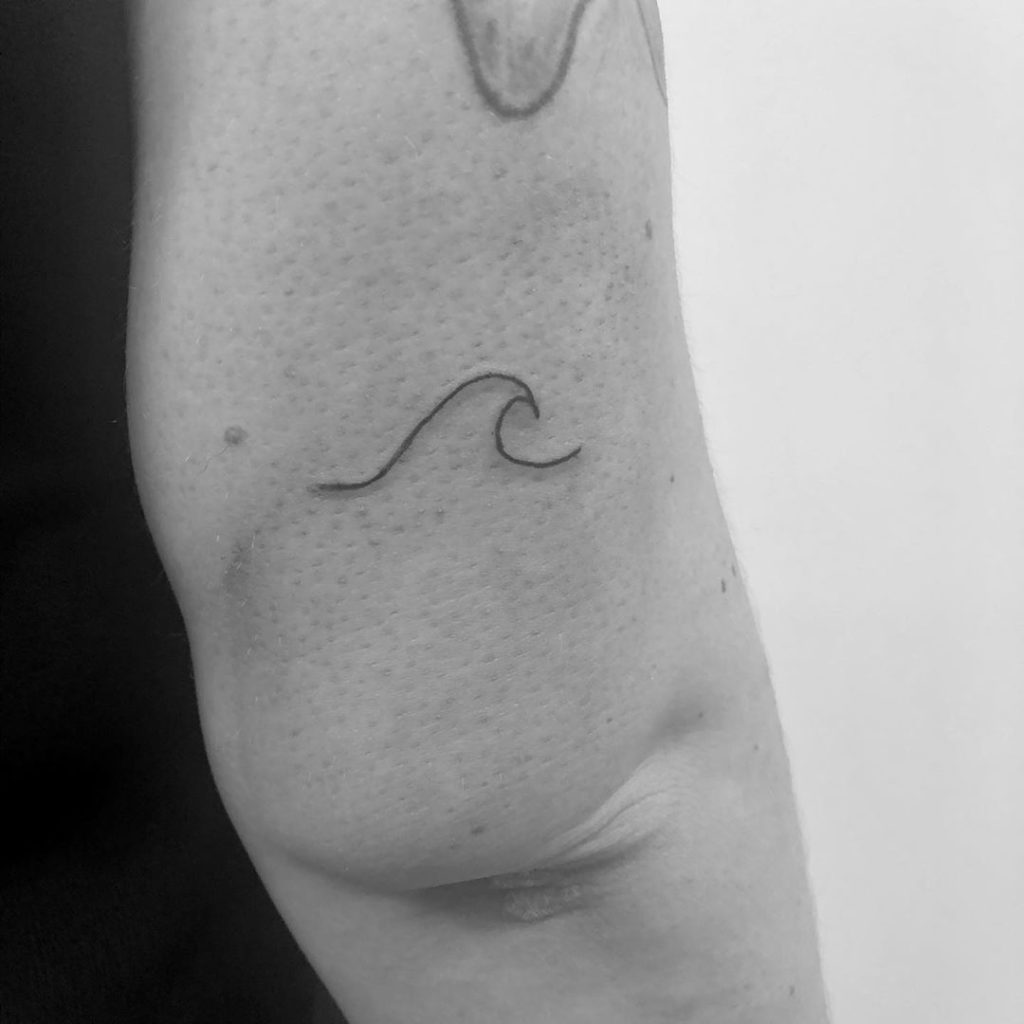 Wave tattoo on Arm (upper) by Louise Heathorn