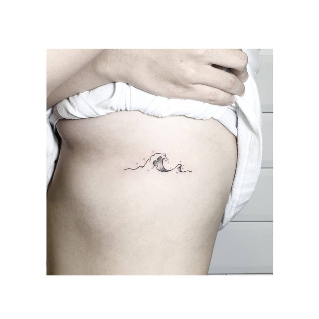 Wave tattoo on Rib by Marta Burgos