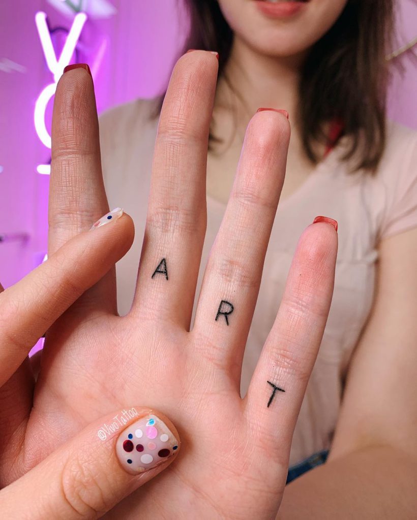 Writing tattoo on Finger by Masha Vivo