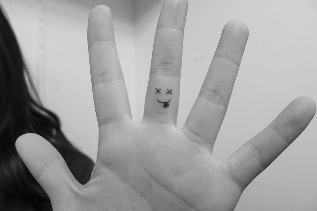 emoji smile  tattoo on Finger by Loko