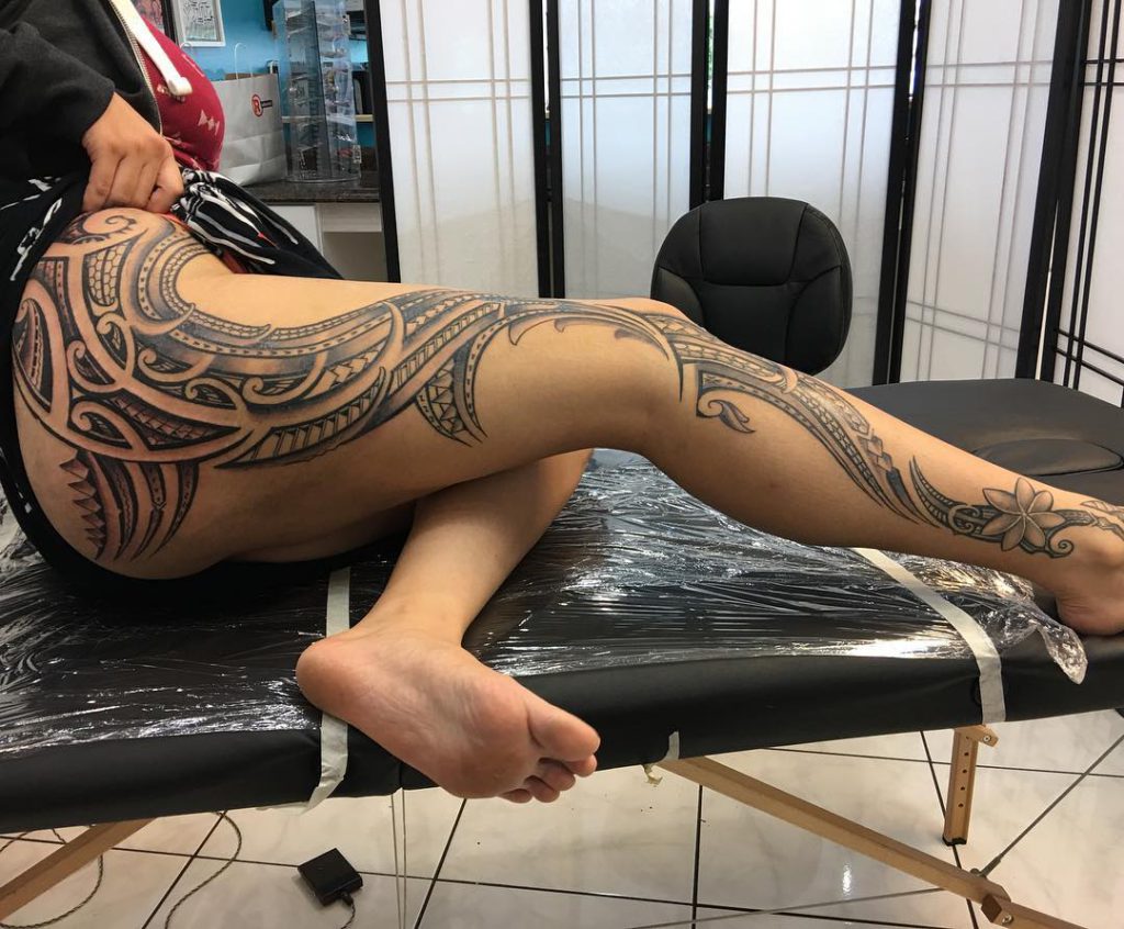 Polynesian leg sleeve tattoo on a woman