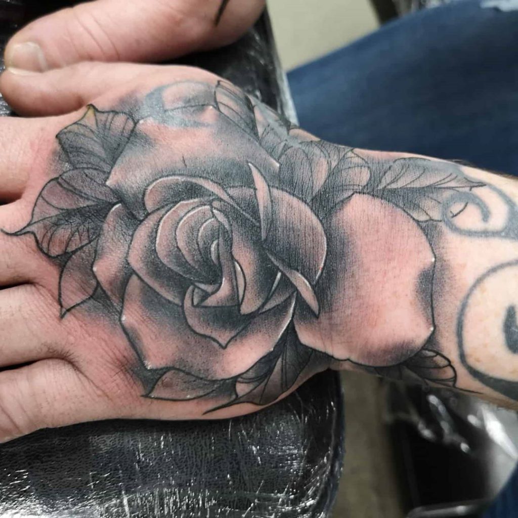 rose flower   tattoo on Hand - Black and Grey style by Dan Brooks