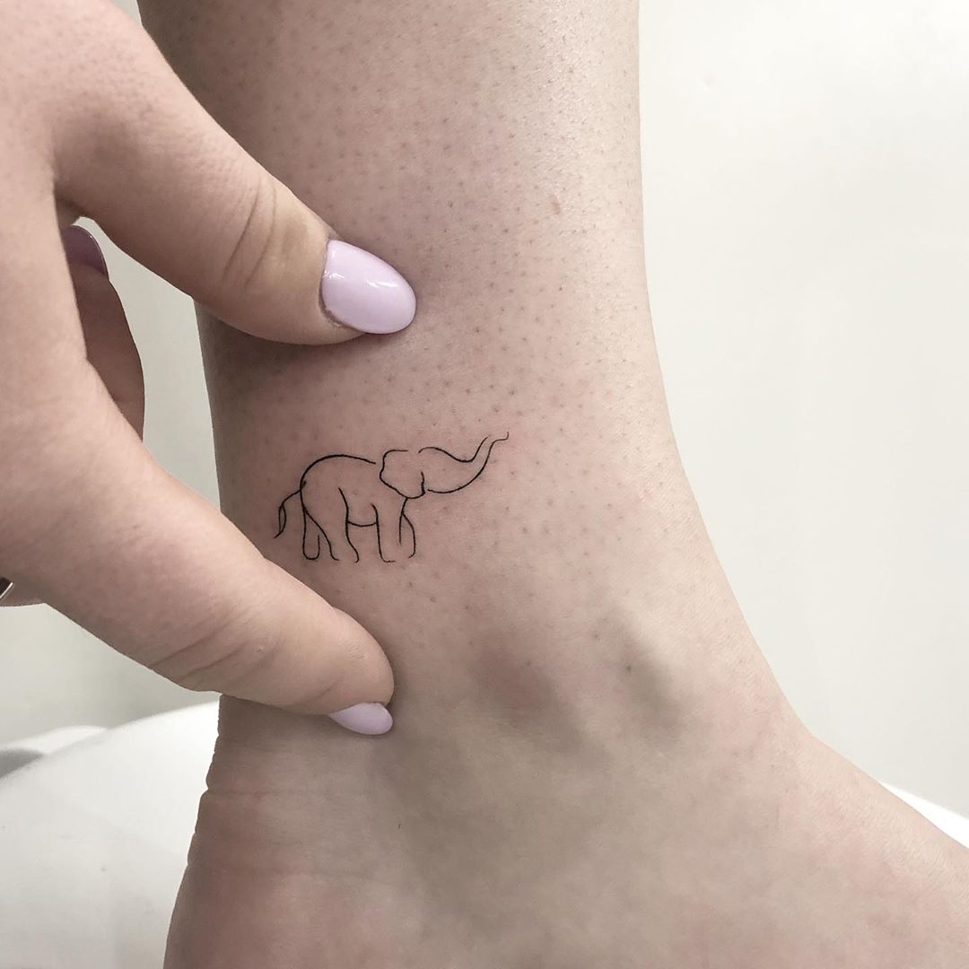 Fine line elephant family tattoo on the inner forearm