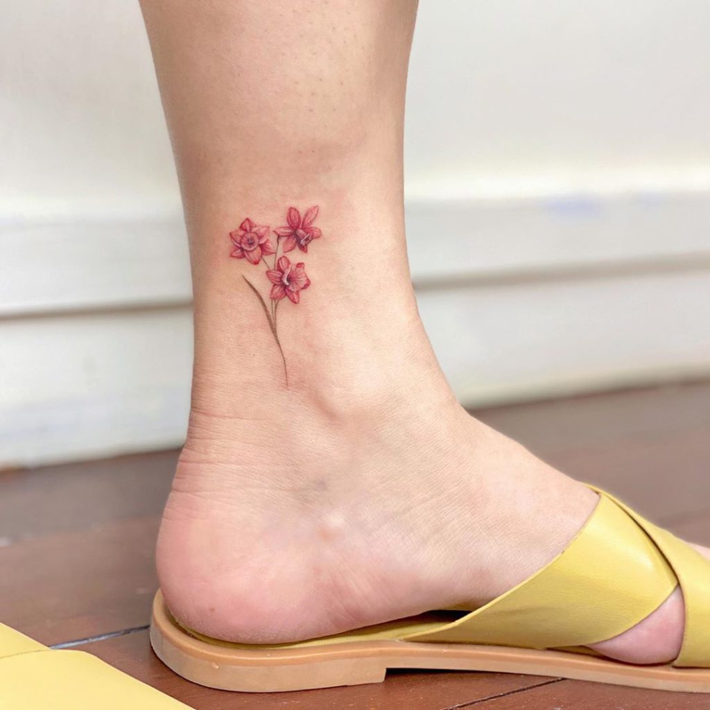 I intricately designed a stunning tattoo, intertwining lily of the valley  and daffodil flowers with her children's names, creating a deep... |  Instagram