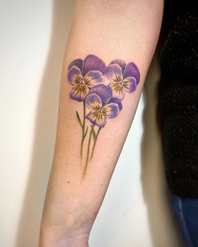 Pansy tattoos on the left inner forearm