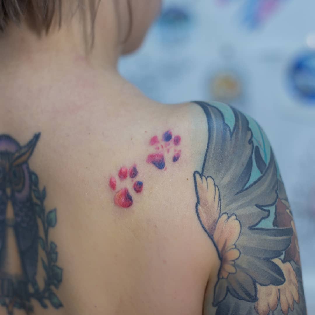 Cat paws tattooed on the inner forearm