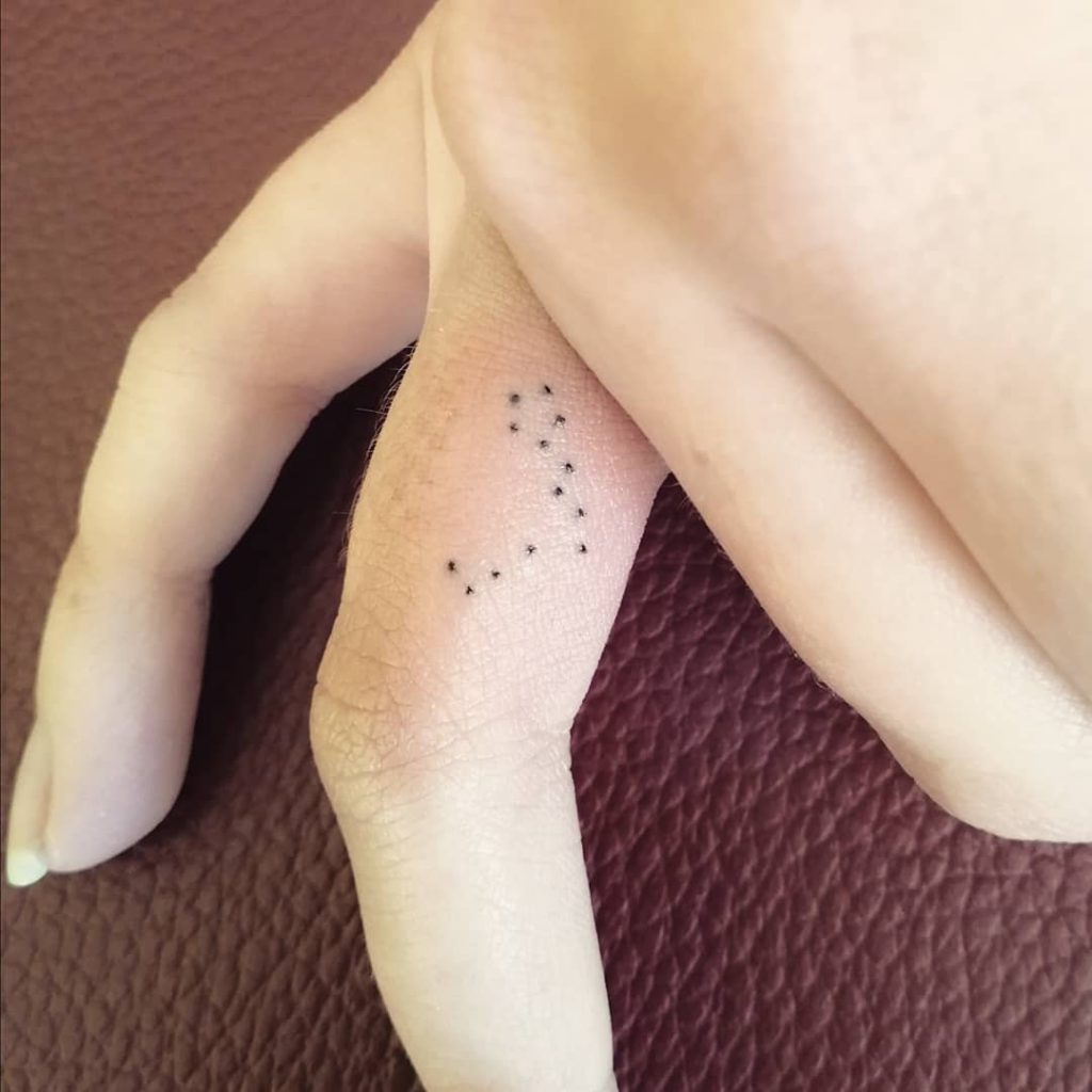 Tiny Pisces Tattoo on Finger by Lyia