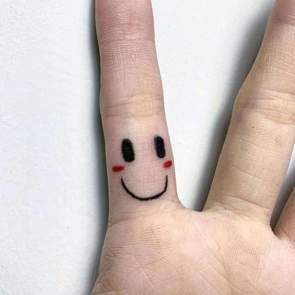 Smiley tattoo on Finger by Harry Wang