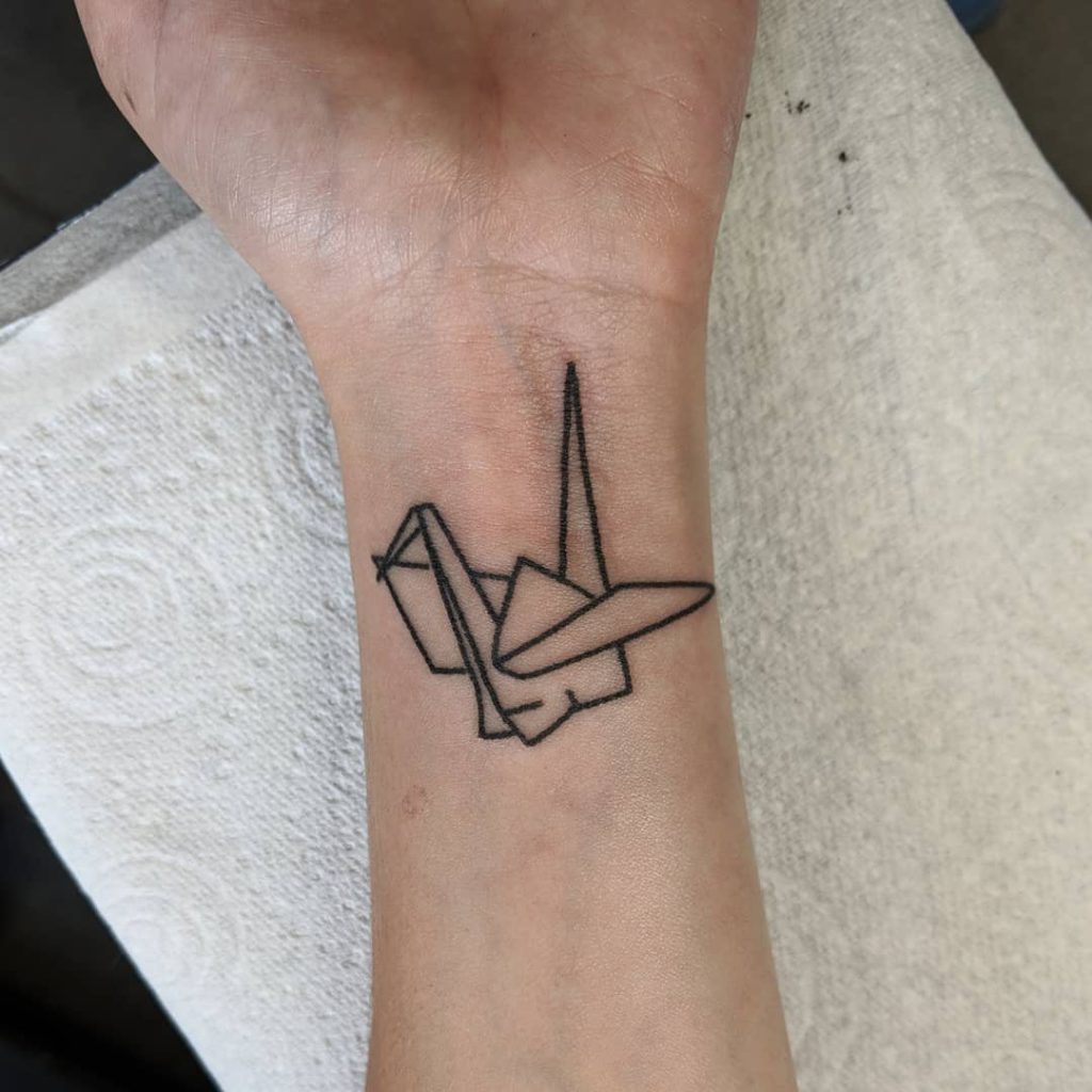 Swan tattoo on Wrist (inner) by Rosie May