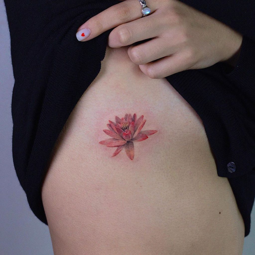 Water lily tattoo on Rib by comotattoo
